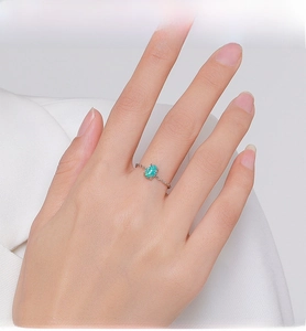 Detail of S925 sterling silver chain ring with oval green opal stone on finger