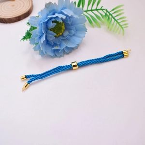 Detailed view of blue woven Milan cord bracelet with 18K gold-plated adjustable slide beads
