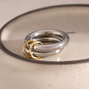 Macro shot of 18k gold plated stainless steel stacked rings with dual band link detail