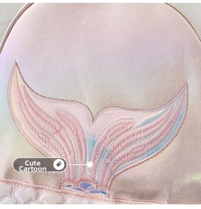 Detailed close-up of embroidered mermaid tail on laser iridescent pink backpack fabric