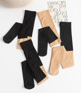 Detail view of thick black and nude thermal pantyhose with reinforced waistband and toes