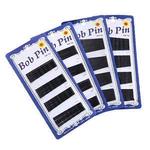 Set of black Bobby pins with ball tips on card packaging for hair styling and fixing