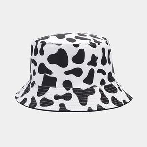 Close-up of black and white cow print bucket hat with durable canvas texture and stitching