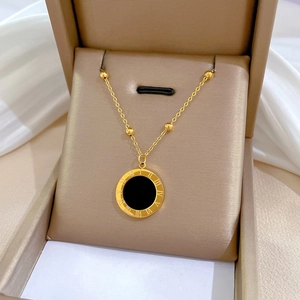 Minimalist gold titanium necklace with Roman numeral shell pendant in a gift box