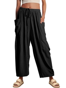 Detail of high waisted black wide leg pants featuring elastic drawstring and cargo side pockets