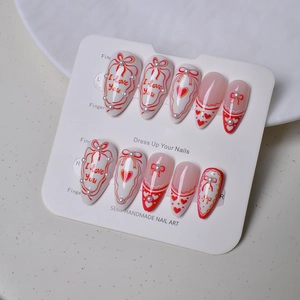 Almond French press-on nails with red hearts, pearls and 'I love you' art text