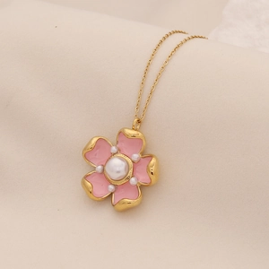 Detailed close-up of pink flower pendant with gold frame and central pearl necklace