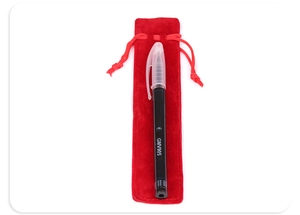Detail view of a thick red velvet drawstring pouch with a sleek black writing pen