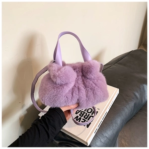Détail du sac seau en fausse fourrure mauve avec des poignées en cuir lisse souple