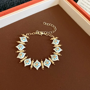 Detailed macro view of vintage gold bracelet with blue enamel and crystal accents