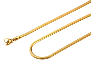Macro shot of gold snake bone chain with lobster clasp on a clean white background