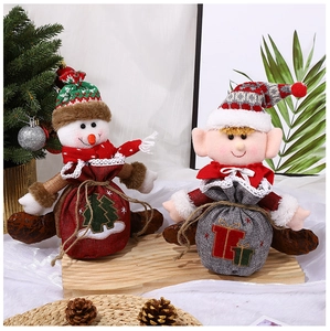 Detail of fabric Christmas gift bags with snowman and elf designs on a festive display