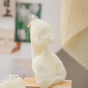 Close-up of a white girl portrait scented candle on a wooden base for home decor