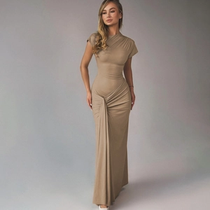 Detailed view of ruched waist design and elegant draped fabric on a khaki maxi dress