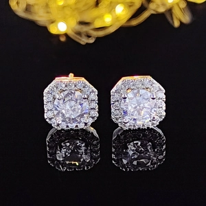 Macro shot of silver octagonal stud earrings with pavé set cubic zirconia and reflections