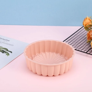 Pink sunflower silicone cake mold with pleated edge and radial texture detail