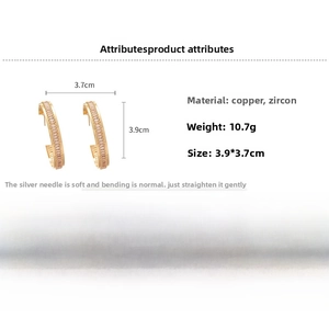 Detail showing 3.9cm golden C-shaped hoop earrings with copper base and zircon stones