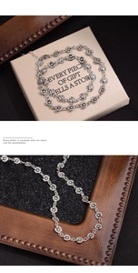 Close-up of vintage silver daisy chain necklace with intricate floral petal details
