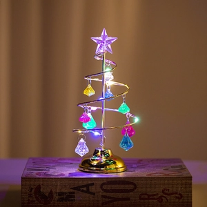 Detail of creative golden spiral metal Christmas tree with crystal pendants and LED lights