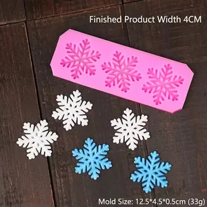 Pink silicone mold for Christmas snowflake fondant featuring three snowflake patterns
