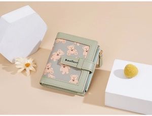Detail of light green bear print women's wallet with metal zipper and snap closure