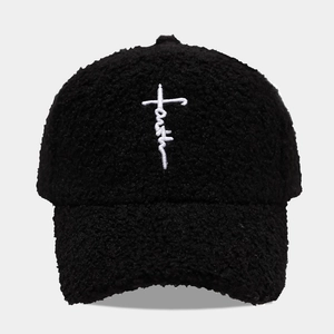 Close-up of black fleece baseball cap with white Faith cross embroidery detail