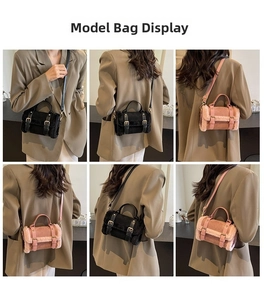 Model wearing a small plush crossbody bag with double buckle straps in black and pink