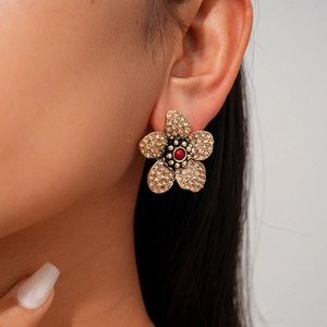 Detail von Vintage-Ohrstecker in Blumenform mit Champagner-Kristallen und roter Perle