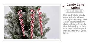 Close-up of red and white spiral candy cane ornaments hanging on a Christmas tree branch
