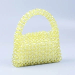 Detailed view of yellow handmade acrylic beaded handbag showing glossy faceted beads