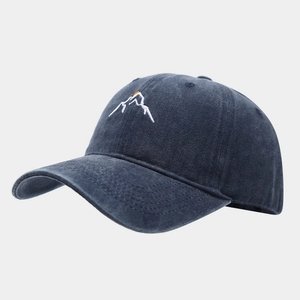 Close-up of mountain peak sunset embroidery on washed cotton baseball cap texture