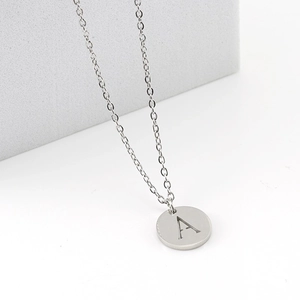 Polished silver stainless steel necklace featuring a round pendant with engraved letter A