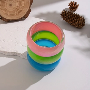 Colorful resin geometric bangles in pink green and blue with a subtle glittery pearlescent finish