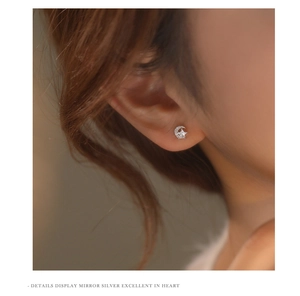 Close-up of model wearing s925 silver crescent moon and star stud earrings with zircon