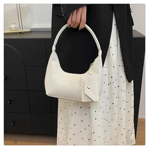 Detail of white crocodile pattern shoulder bag with matching mini coin purse charm