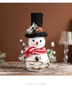 Detail of a white Christmas snowman doll with black top hat and red striped scarf decor