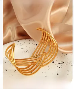 Detail of 18K gold plated wide cuff bracelet with layered wavy hollow leaf patterns