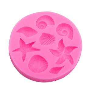 Pink silicone mold with seashell and starfish shapes for ocean theme cake decorating