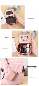 Pink mini vanity case with quilted faux leather, mirror interior, and gold chain charm
