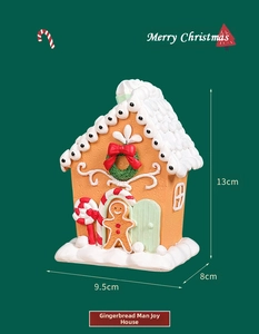 Detailed Christmas gingerbread house ornament with snow roof and candy cane pillars