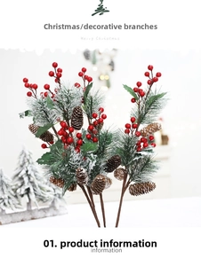 Close-up of artificial cedar branch with red berries, pine cones and faux snow