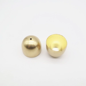 Close-up of polished brass mini bells showing hollow interior and top hole detail