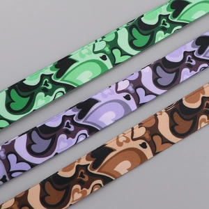 Detail of three colorful polyester lanyards with heart patterns and wavy designs
