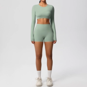Front view of mint green long sleeve crop top and high waist yoga shorts set