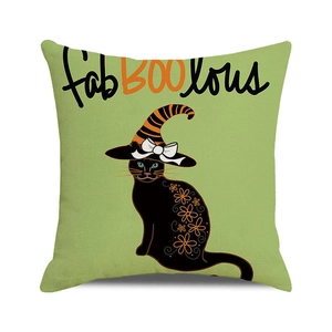 Detailed close-up of a green Halloween cushion cover with a black cat in a wizard hat