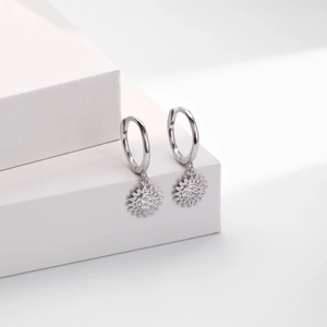 Macro view of S925 sterling silver sunflower drop earrings with cubic zirconia stones