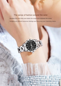 Close-up of women's silver stainless steel watch with black dial and day-date display