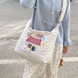 Quilted white tote bag with colorful house embroidery and adjustable shoulder strap