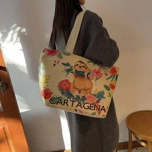 Detailed view of canvas tote bag with sloth and tropical flower print and Cartagena text