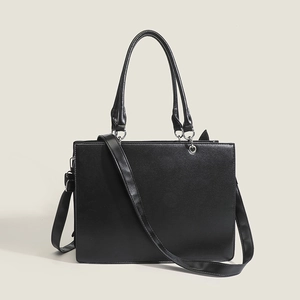 Detailed view of black PU leather tote bag with silver rings and adjustable strap